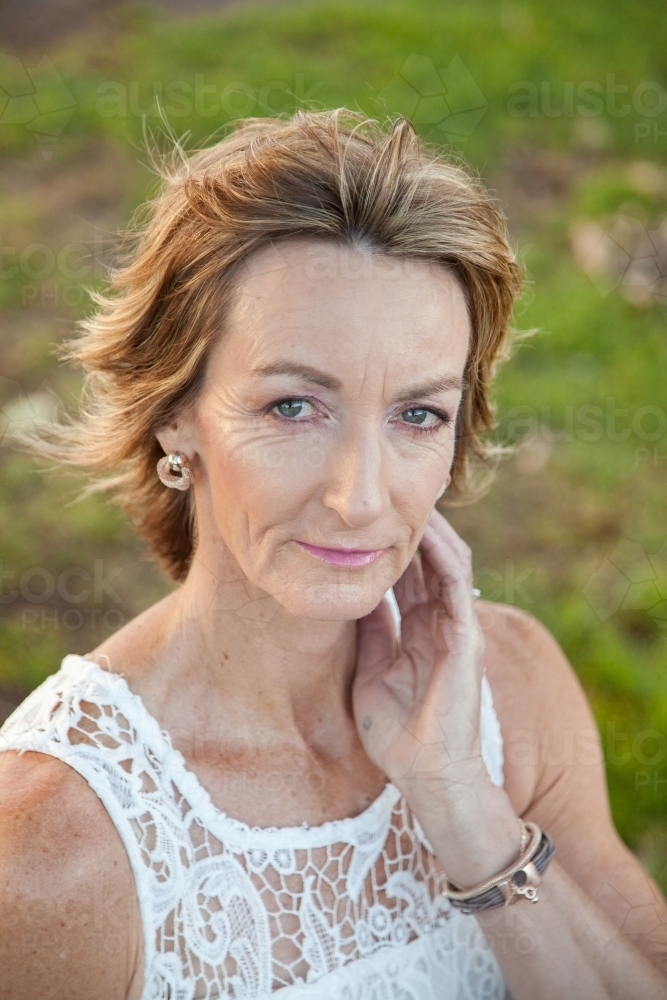 head and shoulders portrait of beautiful middle aged lady - Australian Stock Image