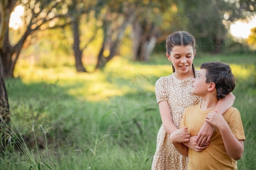 Portrait of brother and sister standing together in Australian country bush setting - Australian Stock Image