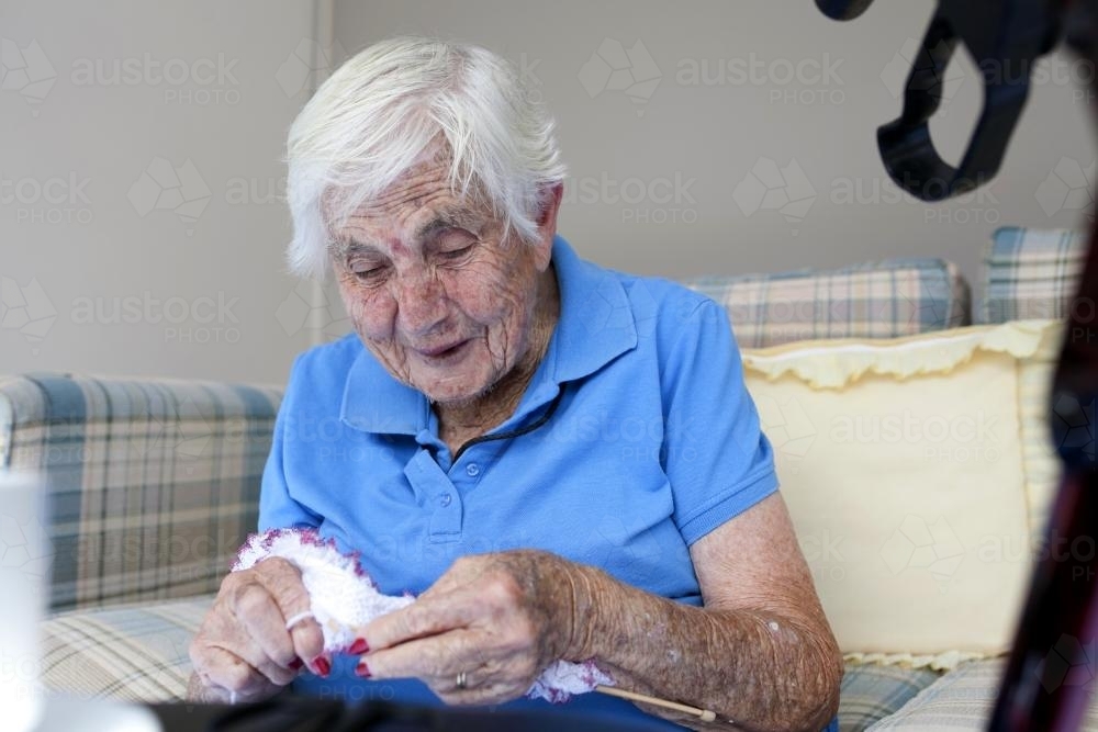 Portrait of elderly retirement village resident knitting - Australian Stock Image