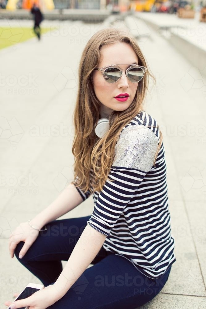 Portrait of fashionable young woman wearing sunglasses - Australian Stock Image