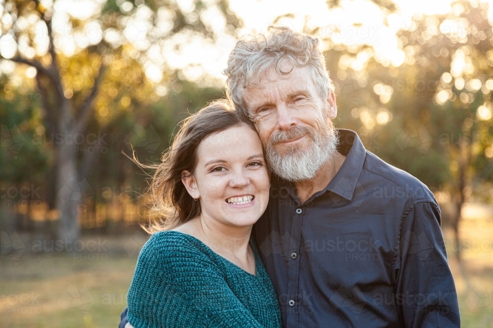 Portrait of father and smiling daughter together - Australian Stock Image
