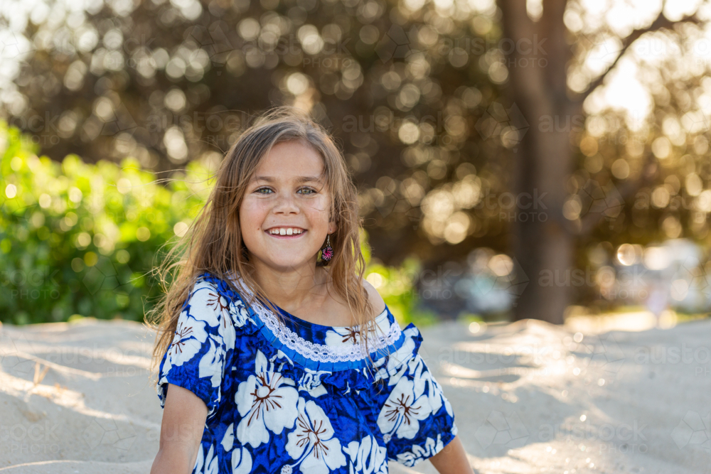Portrait of First Nations Australian Torres Strait Islander child in traditional floral dress - Australian Stock Image