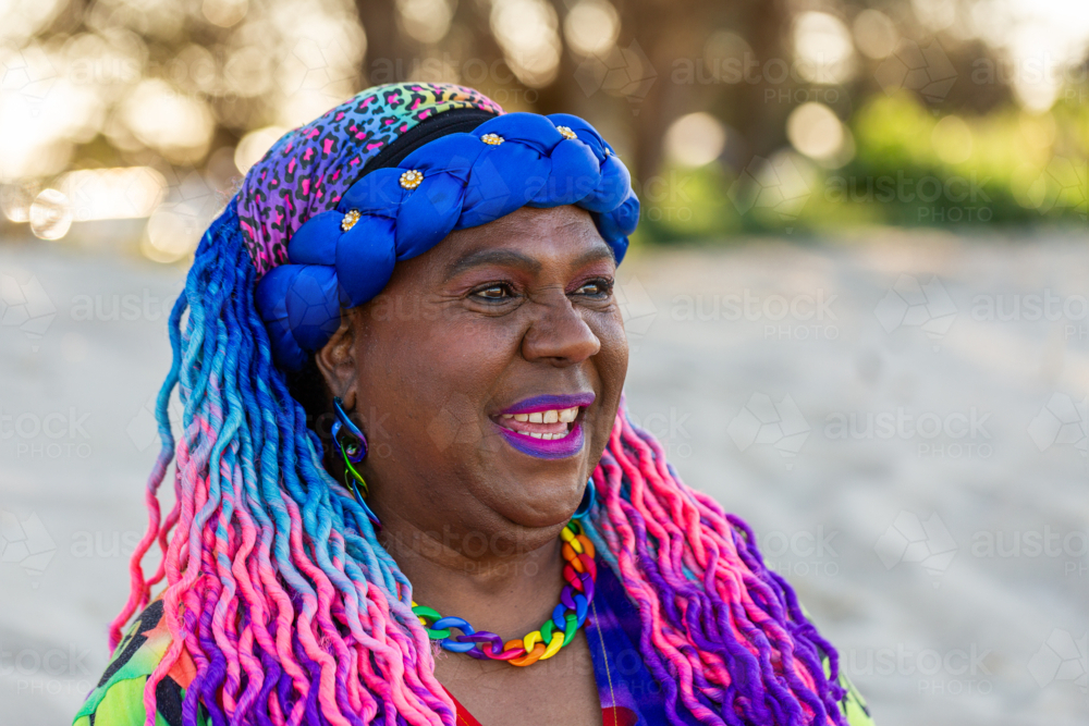 Portrait of First Nations Australian Torres Strait Islander woman in her late fifties at beach - Australian Stock Image