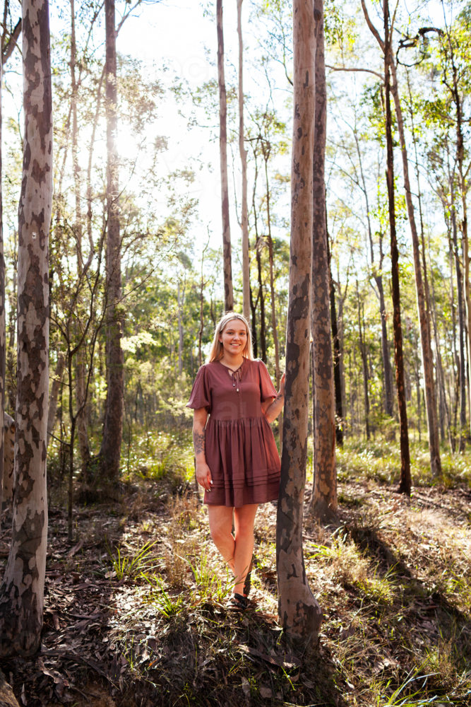 Portrait of First Nations Australian wonnarua woman standing in natural bushland - Australian Stock Image