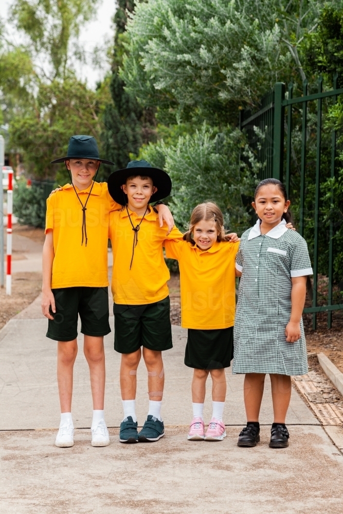 Portrait of four happy school friends at an Australian public school - Australian Stock Image