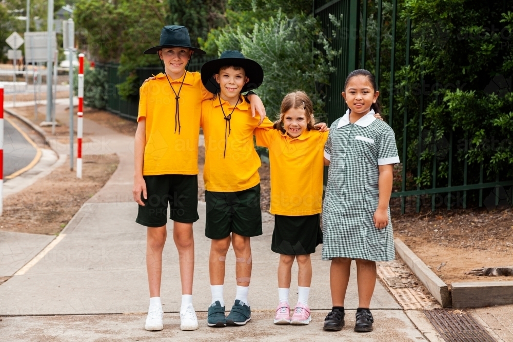 Portrait of four happy school friends at an Australian public school - Australian Stock Image