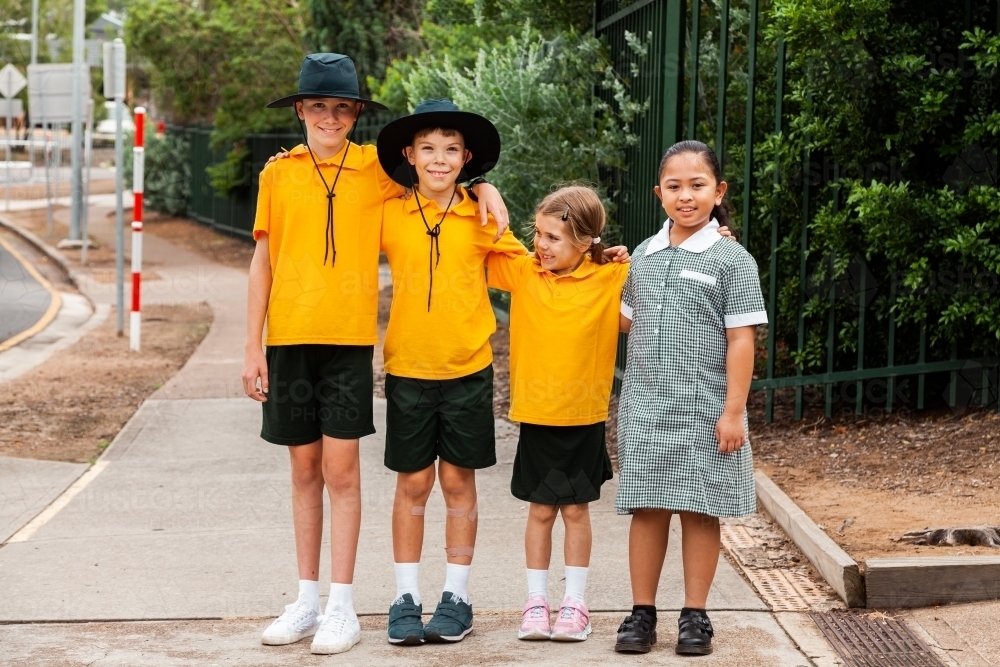 Portrait of four happy school friends at an Australian public school - Australian Stock Image