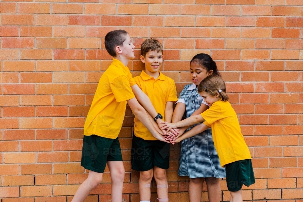 Portrait of four happy school friends at an Australian public school - Australian Stock Image