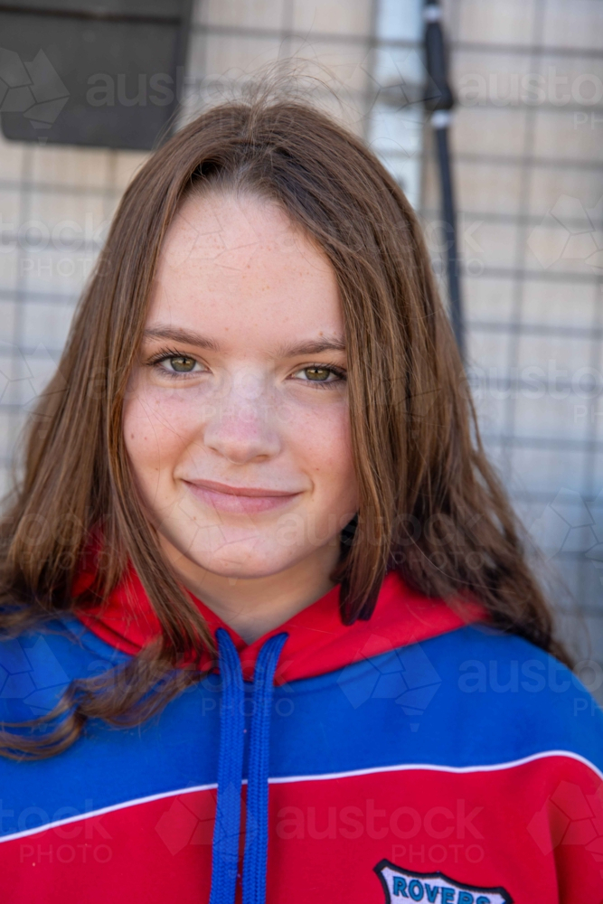 Portrait of girl in sports top smiling - Australian Stock Image