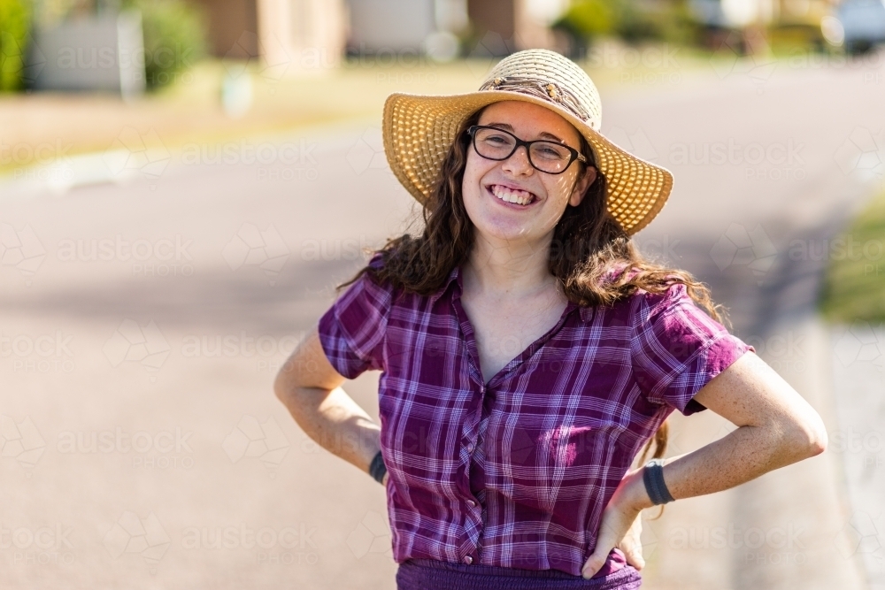 Portrait of grinning happy young aussie woman wearing hat outside - Australian Stock Image