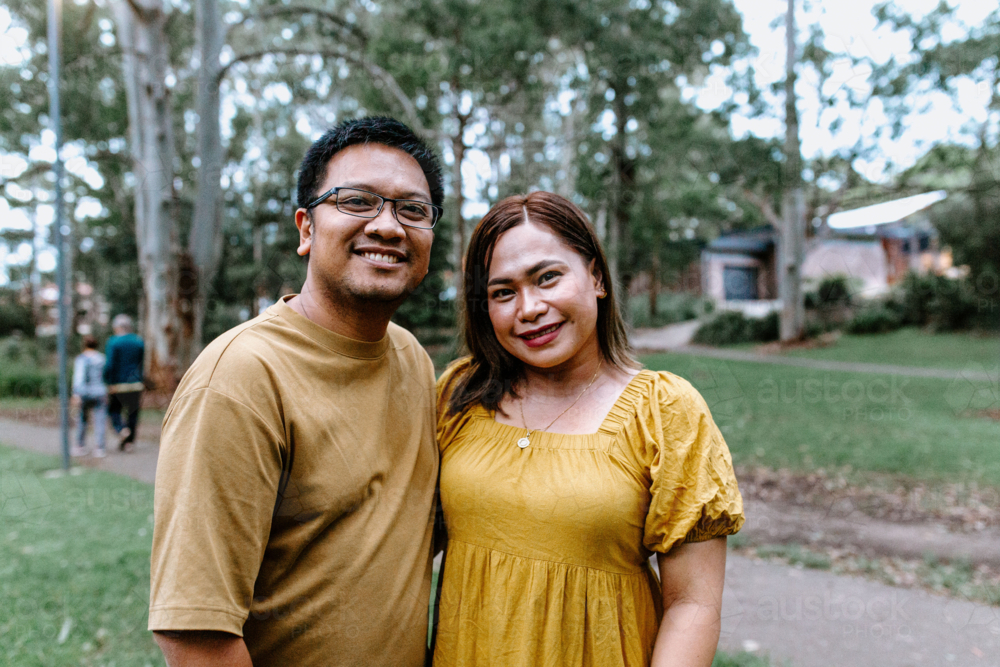 Image of Portrait of happy Asian couple standing at the park - Austockphoto