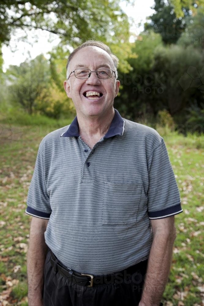 Portrait of happy disabled man standing outside - Australian Stock Image