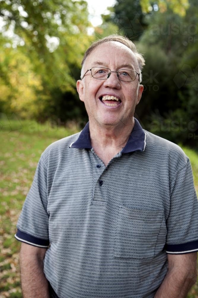Portrait of happy man with a disability standing outside - Australian Stock Image