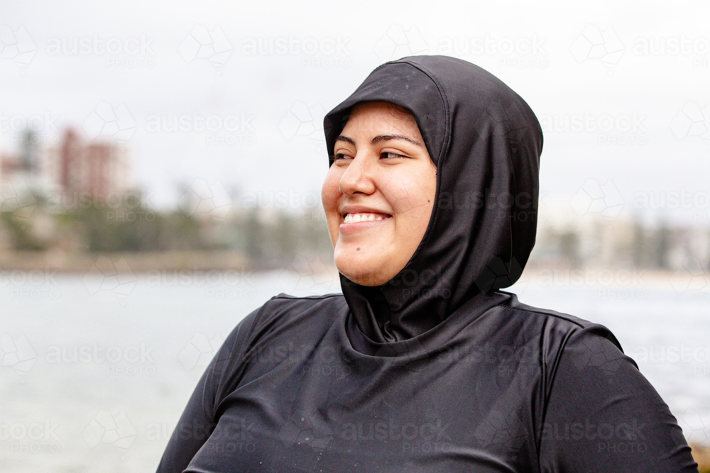 Portrait of happy mixed-race woman at the seaside - Australian Stock Image