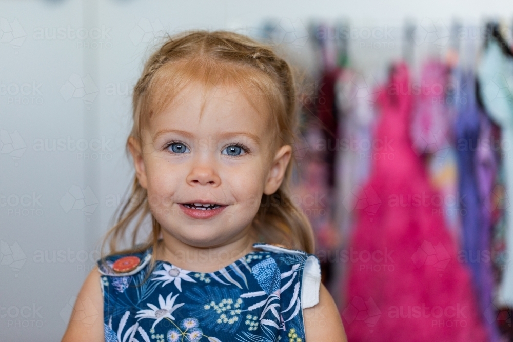 Portrait of happy smiling blue eyed girl indoors - Australian Stock Image