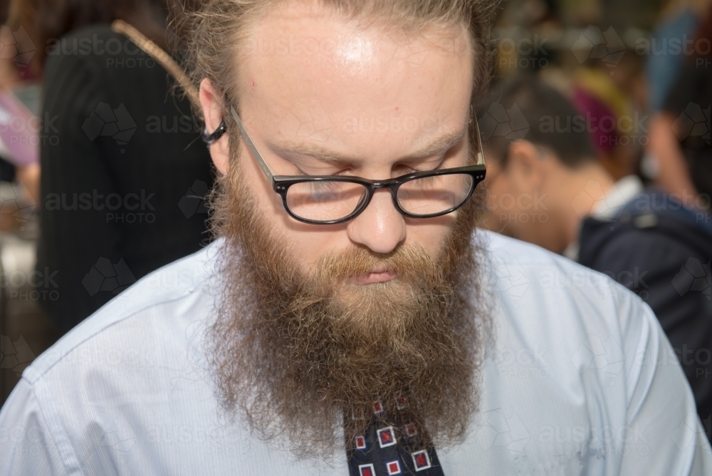 Portrait of hipster businessman looking down - Australian Stock Image