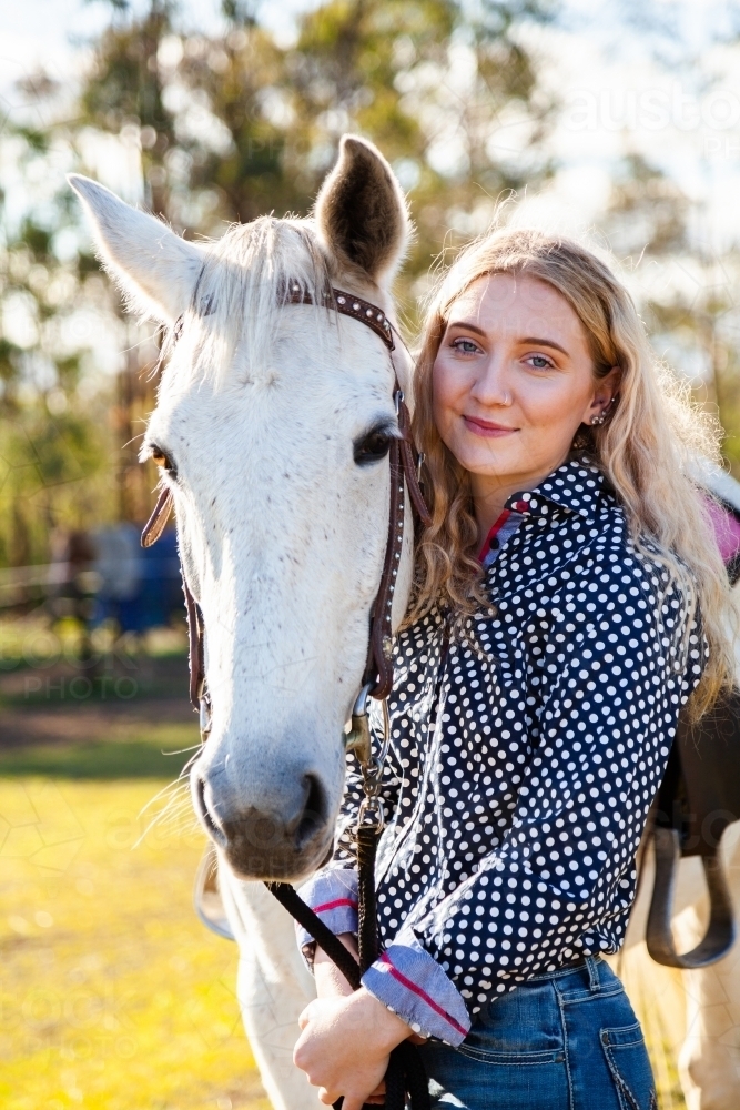 Portrait of horse and smiling happy person - Australian Stock Image