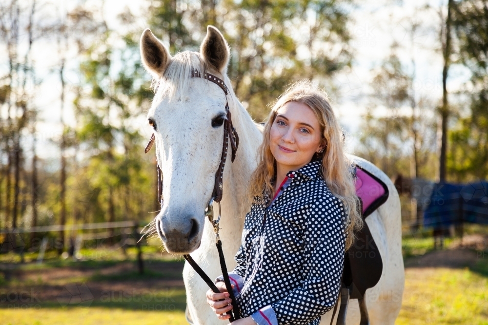 Portrait of horse and smiling happy person - Australian Stock Image
