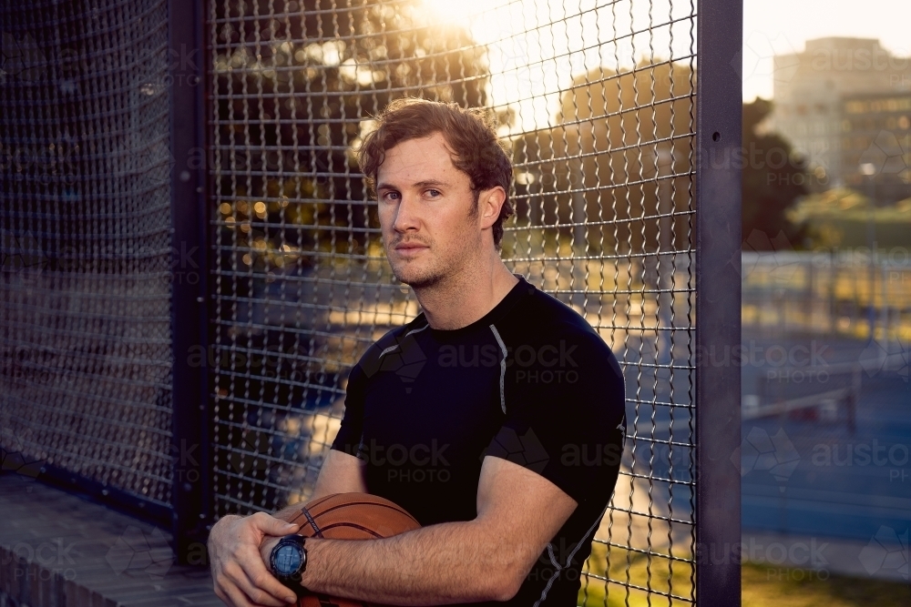 Portrait of man holding basketball - Australian Stock Image