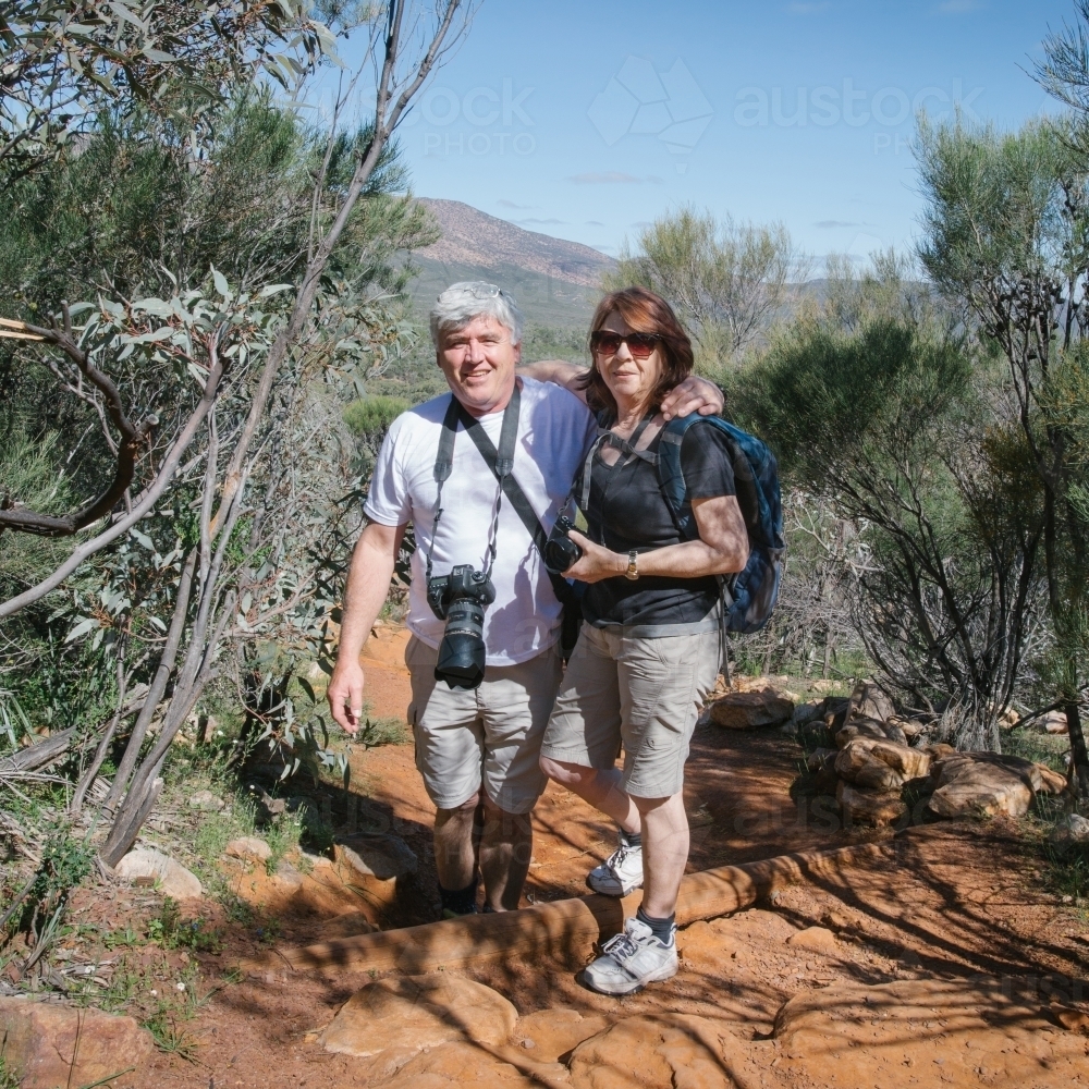 Portrait of middle aged couple in the flinders ranges on a bush walk - Australian Stock Image