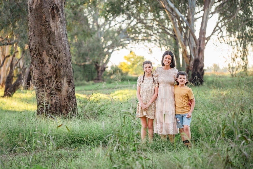 Image of Portrait of mother and children standing together in ...
