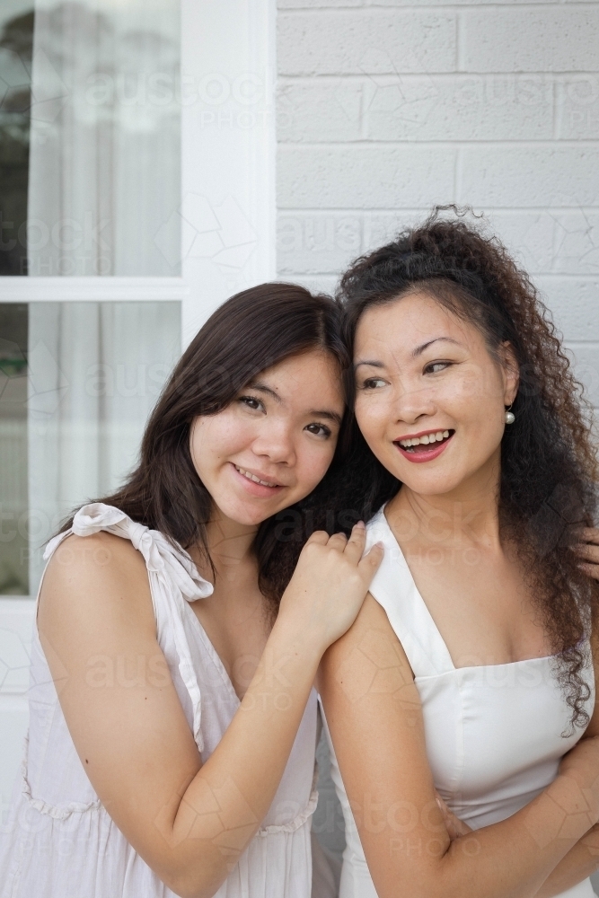 Portrait of mother and daughter smiling - Australian Stock Image