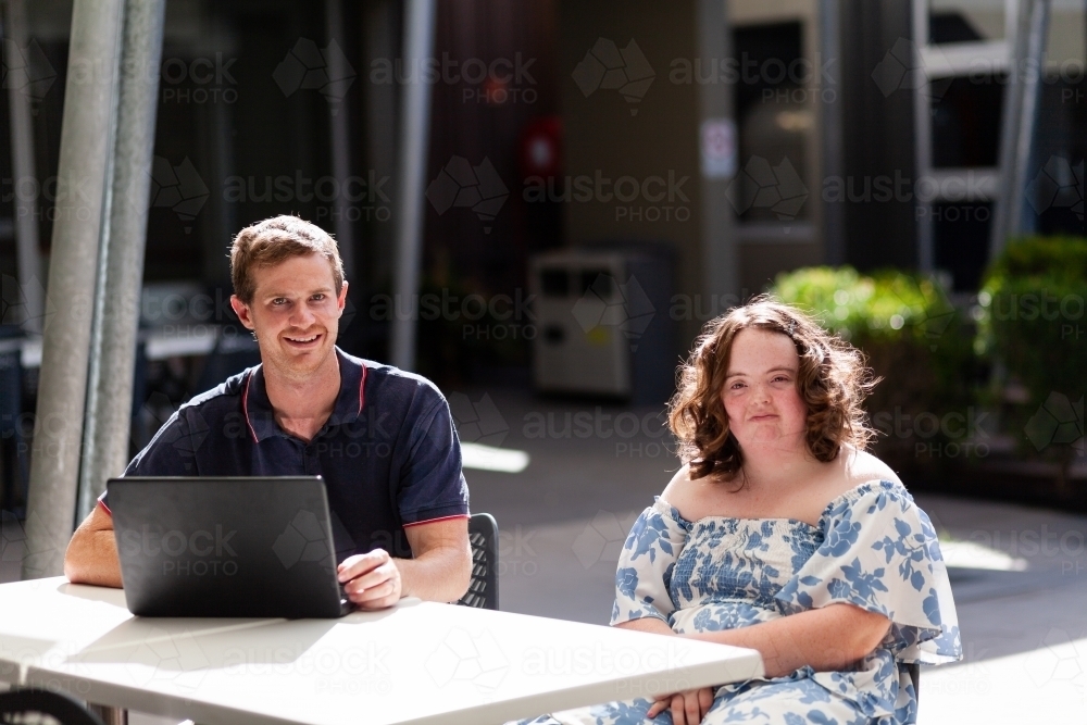 Portrait of NDIS provider disability worker and young teen client with down syndrome - Australian Stock Image