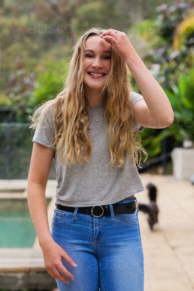 portrait of happy teen in jeans and tee-shirt - Australian Stock Image