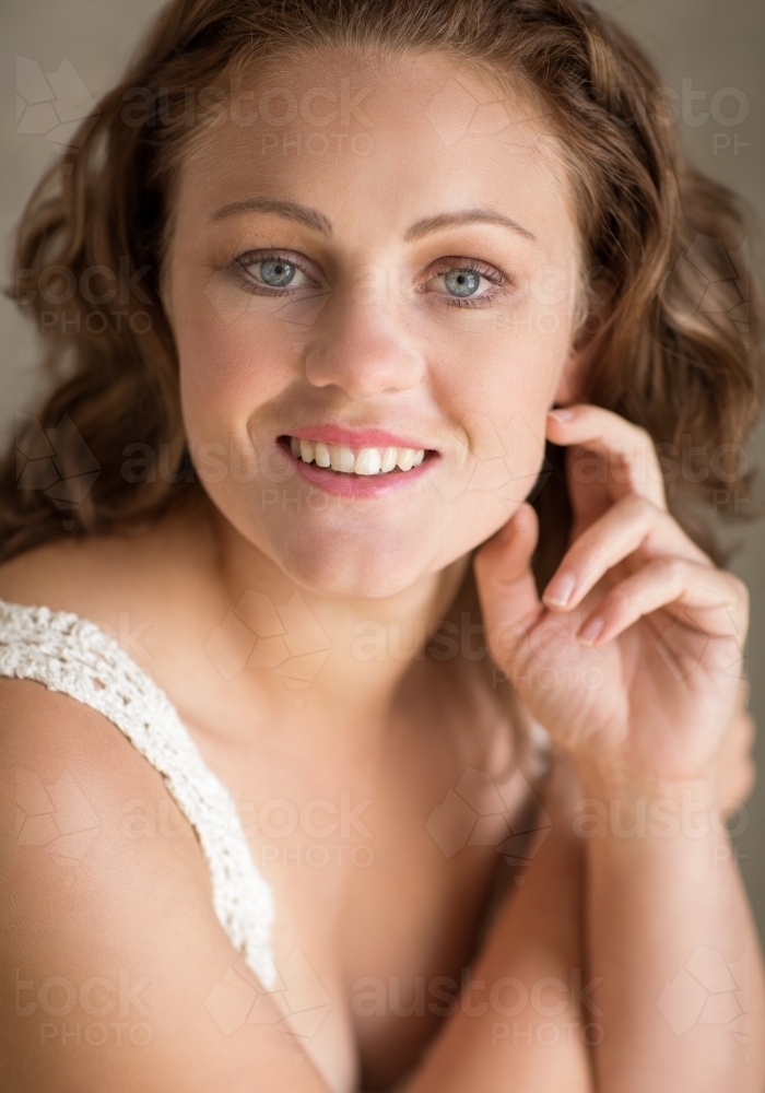 Portrait of pretty young woman smiling at camera - Australian Stock Image