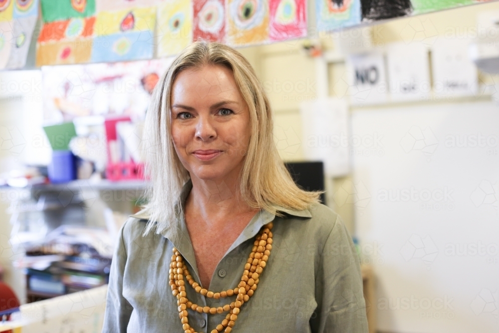 Portrait of school teacher in the classroom. - Australian Stock Image