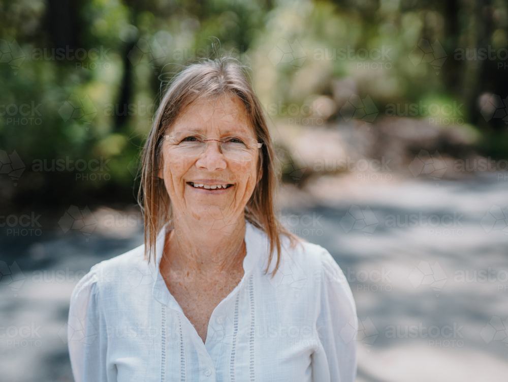 Portrait of senior woman enjoying a healthy lifestyle in nature - Australian Stock Image