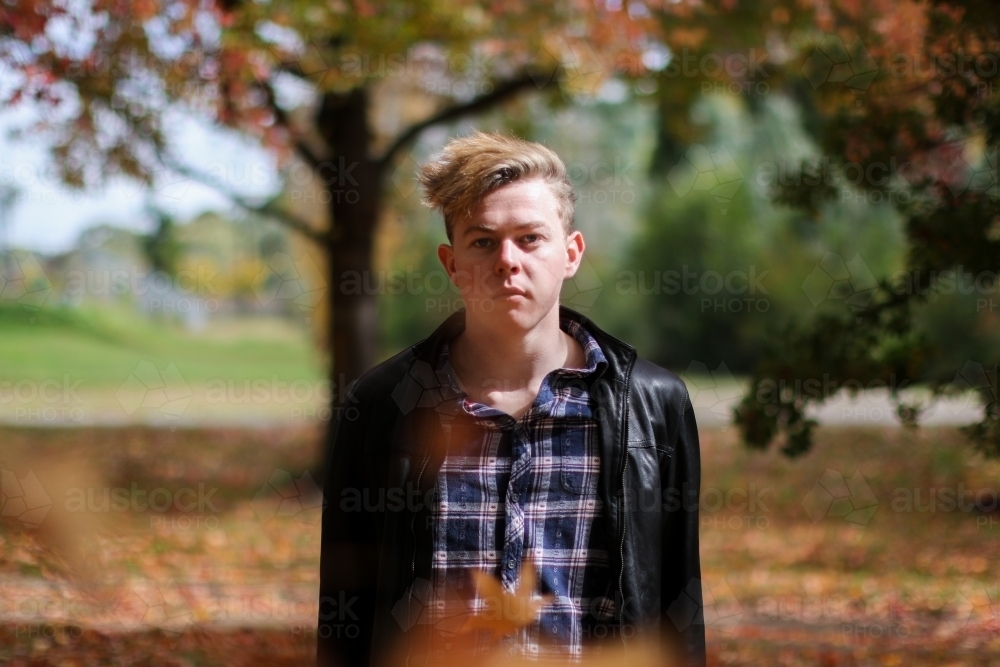 Portrait of serious young man in outdoor setting - Australian Stock Image