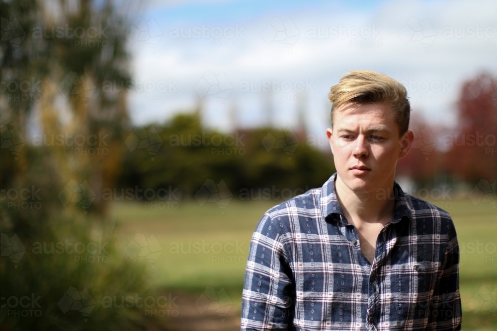 Portrait of serious young man in outdoor setting - Australian Stock Image