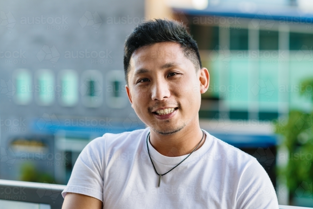 portrait of smiling asian man - Australian Stock Image