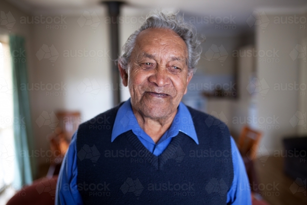 Portrait of smiling elderly man at home - Australian Stock Image