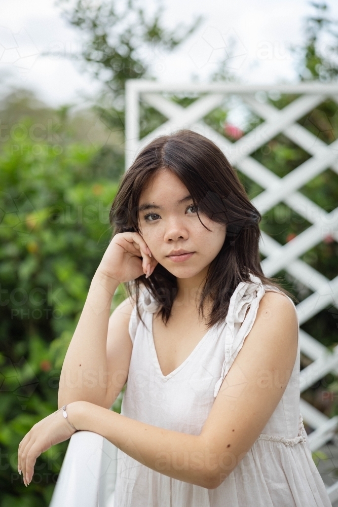 Portrait of teenage girl leaning on railing - Australian Stock Image