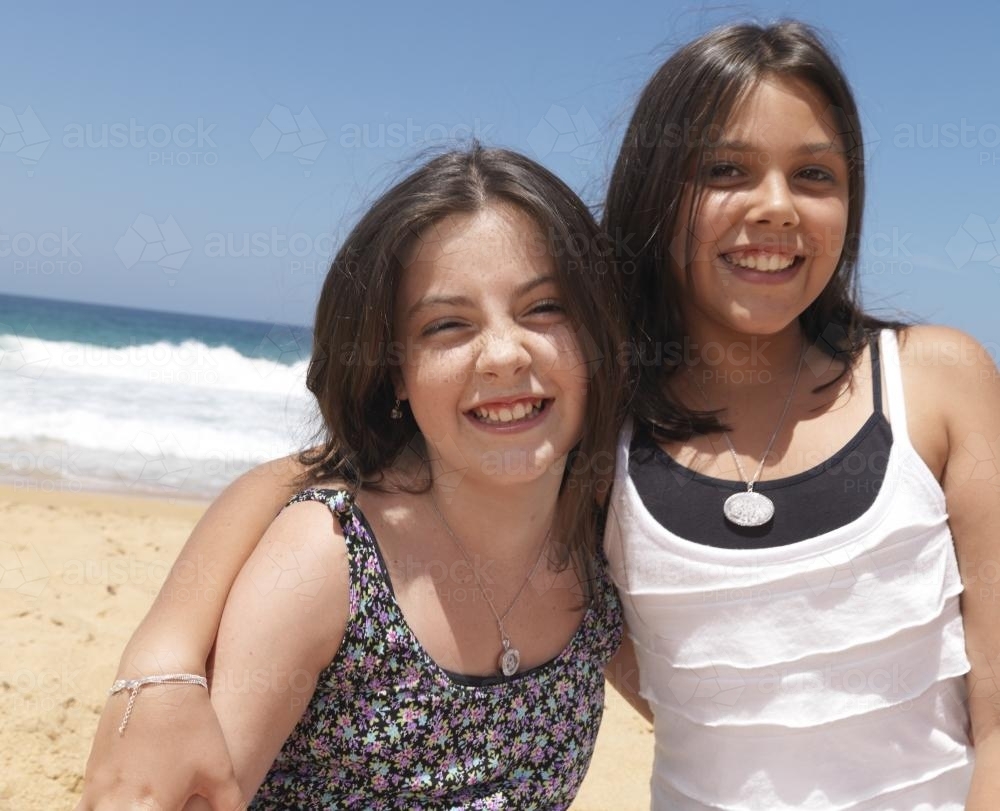 Portrait of teenage sisters at beach - Australian Stock Image