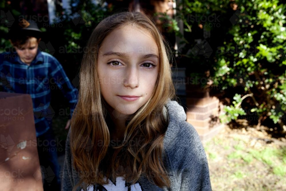 Portrait of teenager standing outside in garden - Australian Stock Image