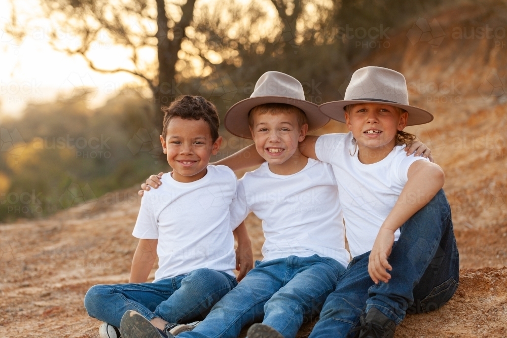 Portrait of three happy Aboriginal brothers in rural country setting - Australian Stock Image