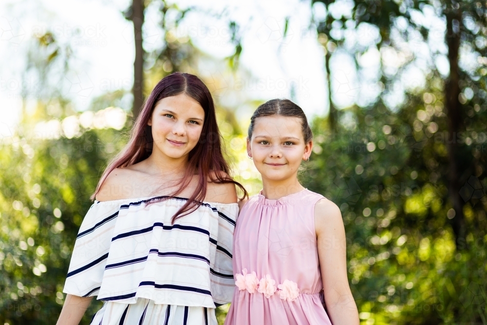 Image Of Portrait Of Tween Sisters With Natural Outdoor Background