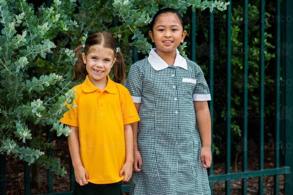 Portrait of two happy school girls looking forward to going back to school - Australian Stock Image