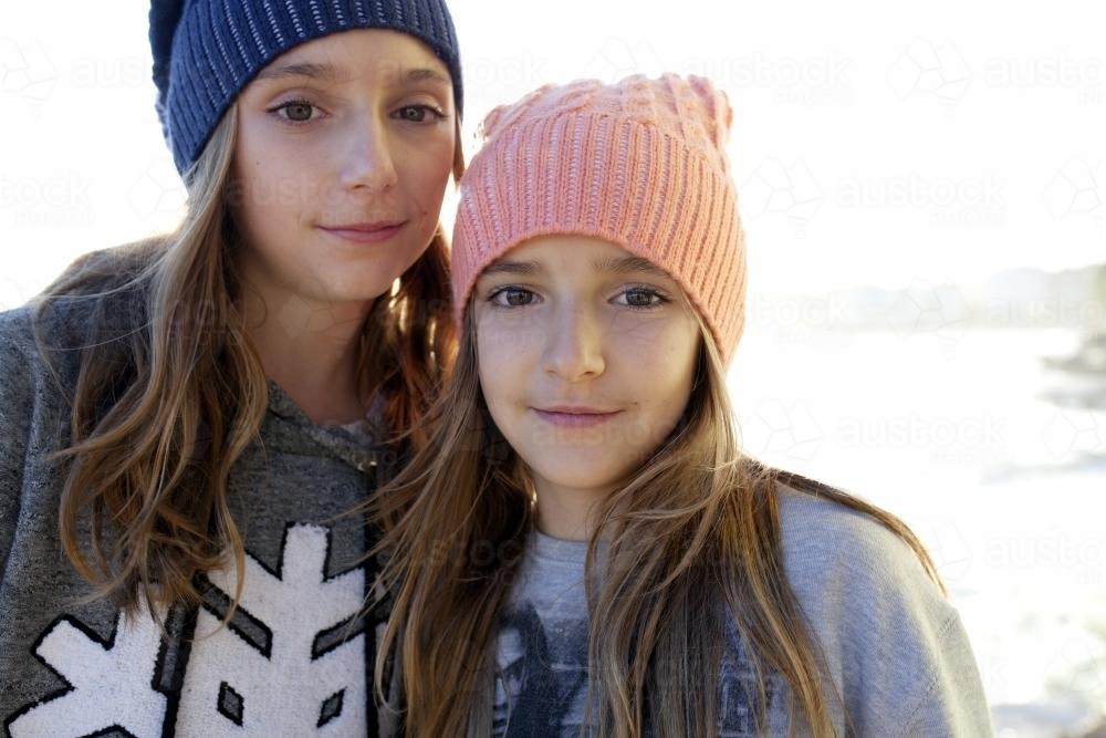 Portrait of two young girls by the ocean - Australian Stock Image