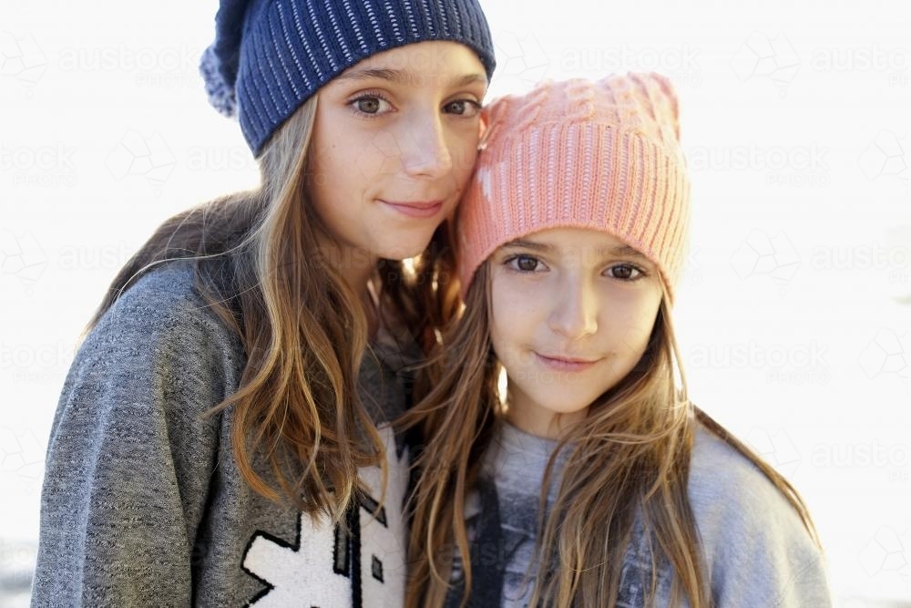 Portrait of two young girls by the ocean - Australian Stock Image