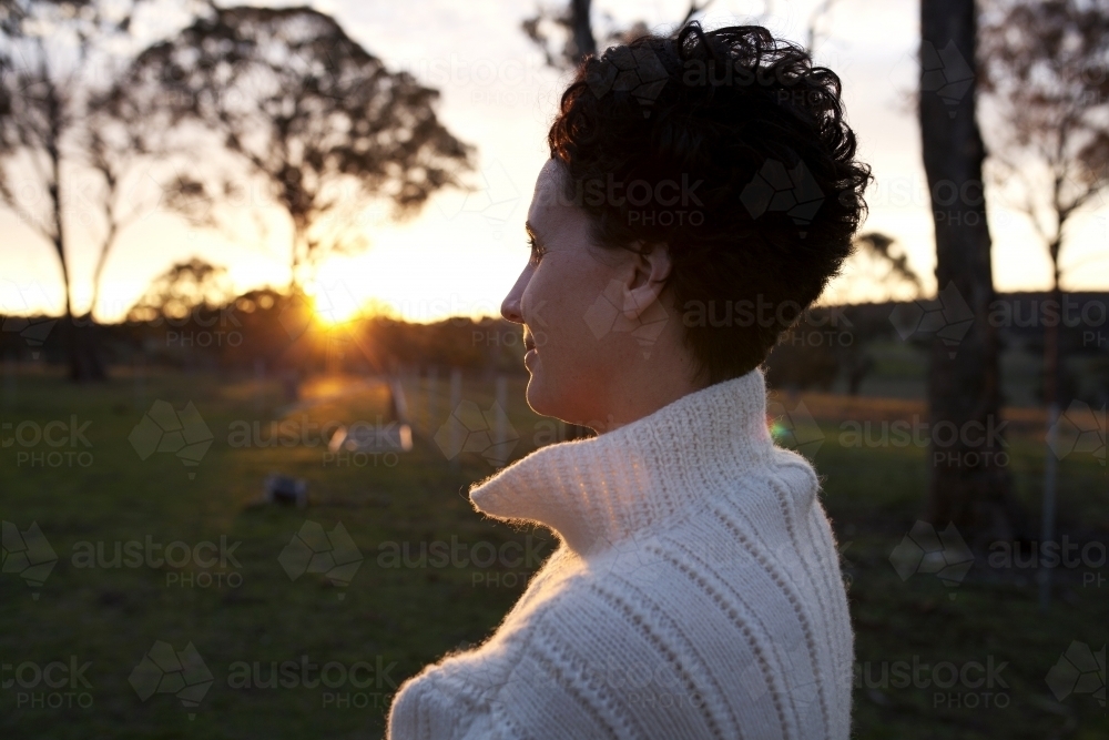 Portrait of woman looking away in the sunset - Australian Stock Image