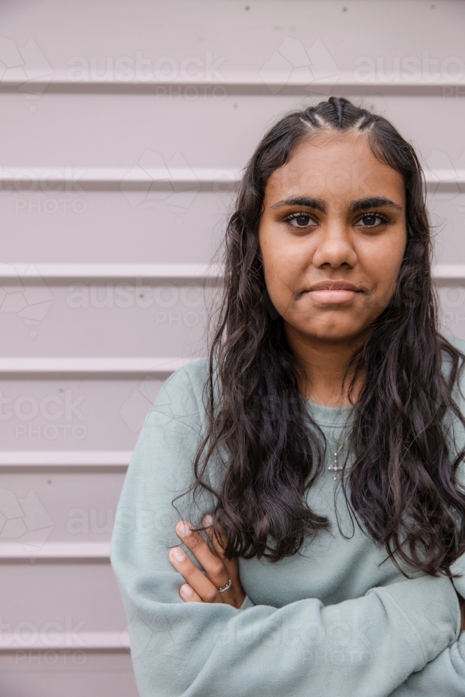 Portrait of young Aboriginal woman with folded arms - Australian Stock Image