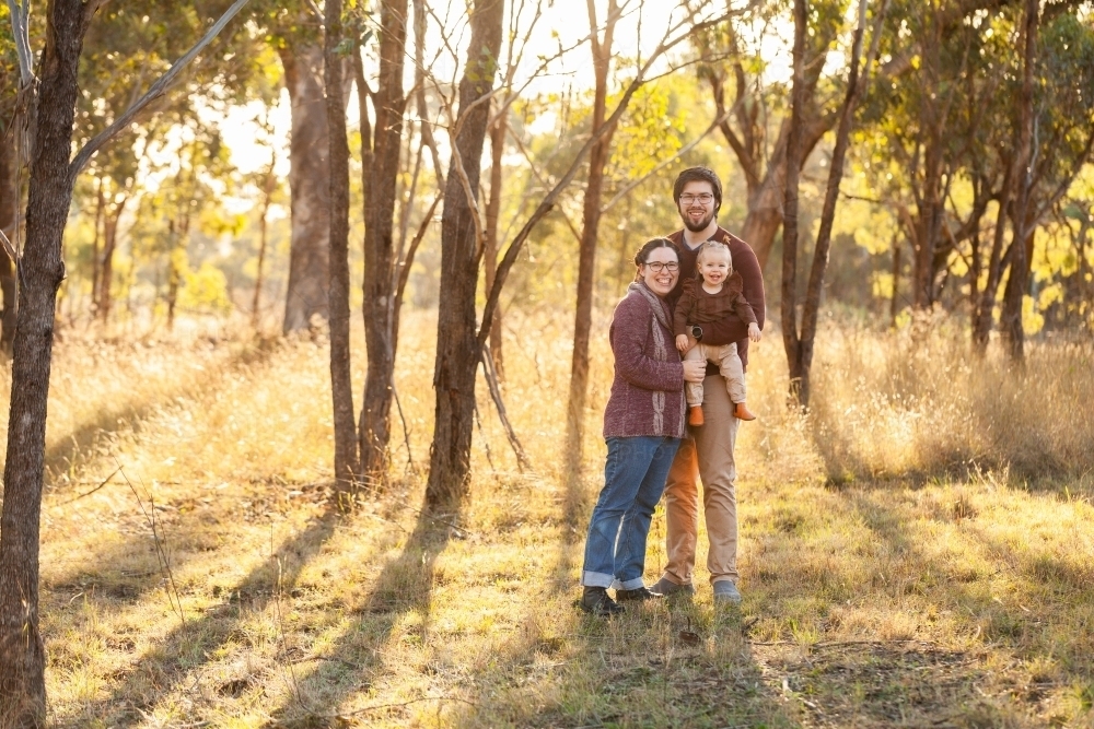 Portrait of young australian family in bushland with copy space - Australian Stock Image