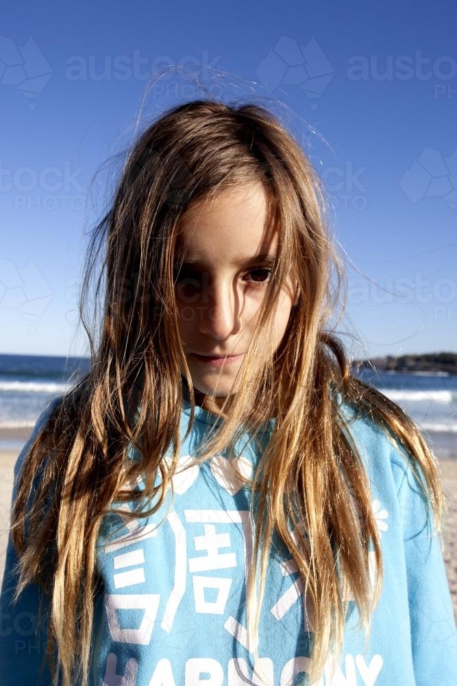 Portrait of young girl at the beach in winter - Australian Stock Image