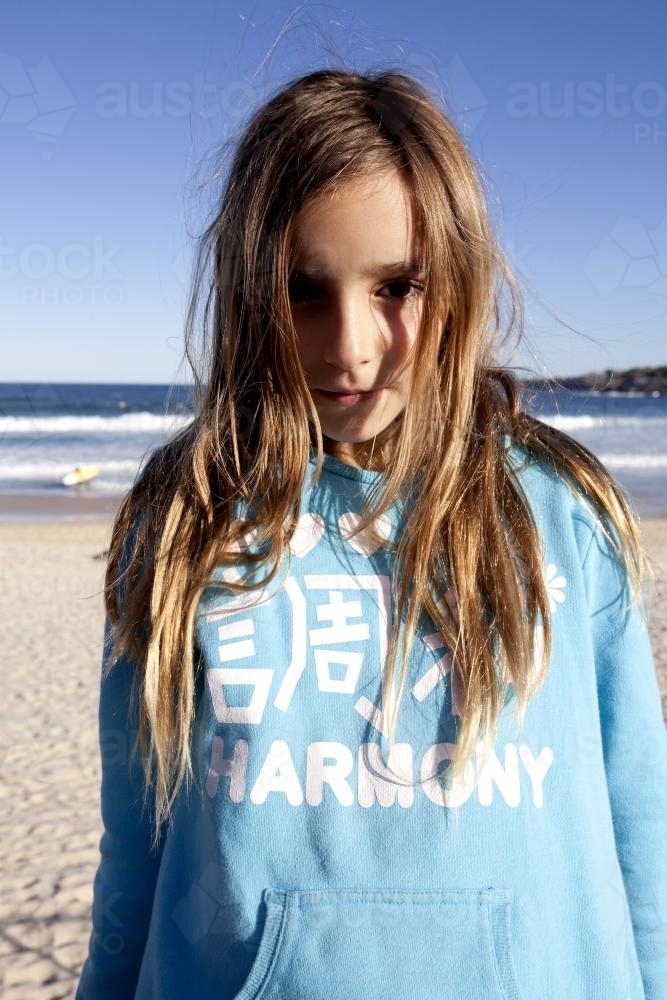 Portrait of young girl at the beach in winter - Australian Stock Image