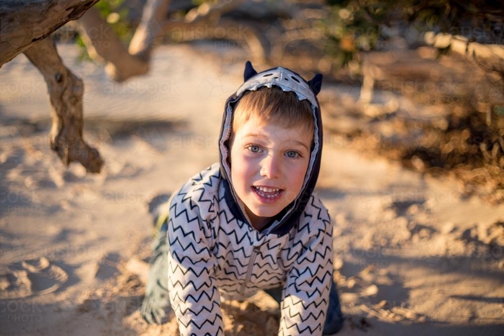 Portrait of young happy boy outdoors wearing hoodie - Australian Stock Image
