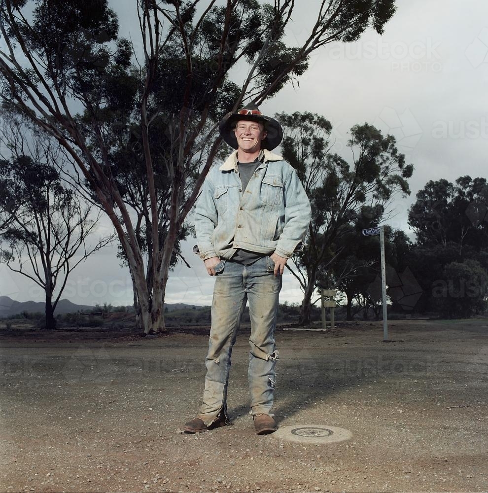 Portrait of young male rural worker standing on street in remote loaction - Australian Stock Image